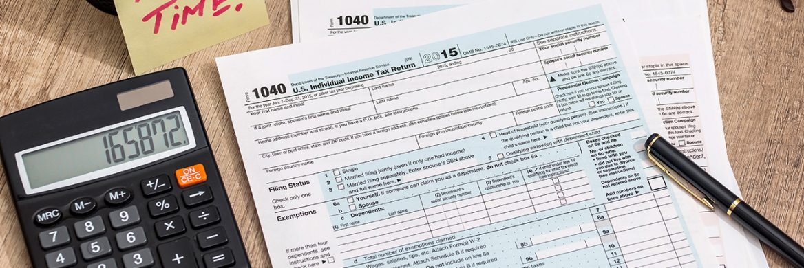 Tax form with calculator, money and pen